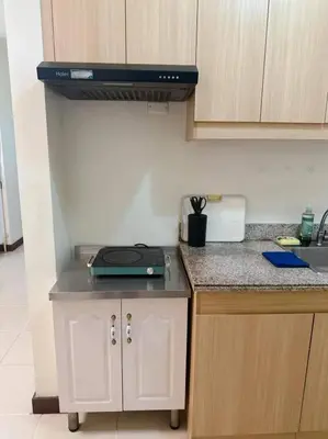 a kitchen with a stove and a counter top at Tan condo city view 01 in Manila
