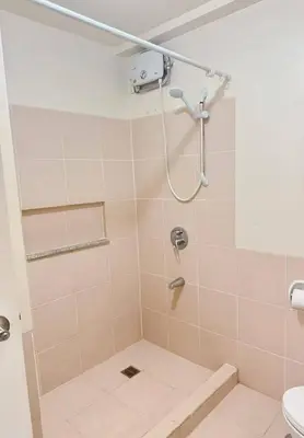 a bathroom with a shower with a toilet at Tan condo city view 01 in Manila