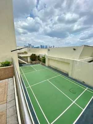 a tennis court on the roof of a building at JL Suite Staycation near Venice Grand Canal Mall in Manila