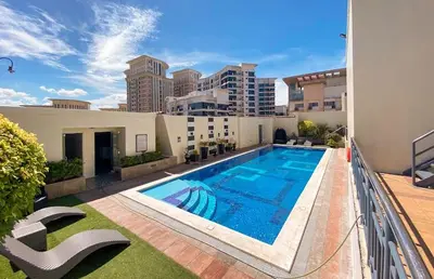 a swimming pool on top of a building at JL Suite Staycation near Venice Grand Canal Mall in Manila