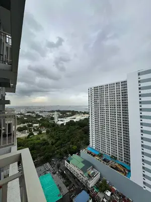 a view of a tall building from a balcony at Staycation Manila at Coast Residences in Manila