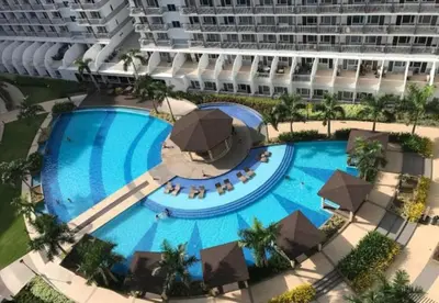 an overhead view of a large swimming pool with a large building at Unistay SHELL Residence Amazing pool near MOA in Manila