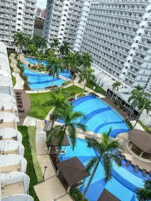 an overhead view of a pool with palm trees and buildings at Unistay SHELL Residence Amazing pool near MOA in Manila
