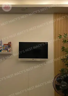 a flat screen tv hanging on a wall at Macy's Nest - Shore 2 Tower 1 in Manila
