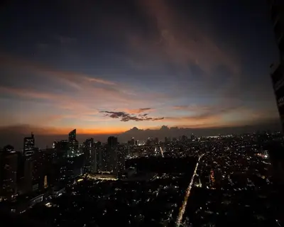 a view of a city skyline at night at Gramercy Residences Cozy 1BR Suite with 600mbps & Free amenities City view in Manila
