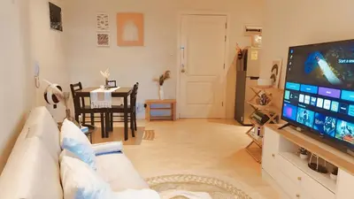 a living room with a couch and a flat screen tv at Gramercy Residences Cozy 1BR Suite with 600mbps & Free amenities City view in Manila