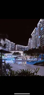 a view of a beach at night with tall buildings at Azure Hawz of Kaws- 2Bedroom Best beach view in Manila
