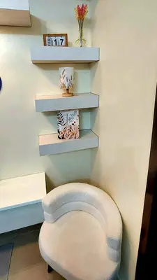 a stool in a room with shelves on the wall at 21K Pioneer Woodlands Mandaluyong in Manila