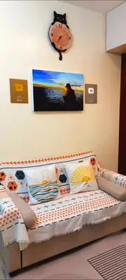 a bedroom with a bed and a clock on the wall at 21K Pioneer Woodlands Mandaluyong in Manila