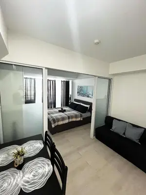 a living room with a bed and a couch at Azure Staycation by Casa Lepap in Manila