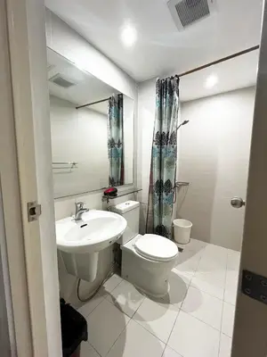 a bathroom with a toilet and a sink at Azure Staycation by Casa Lepap in Manila