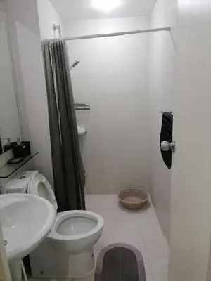 a bathroom with a toilet and a sink and a shower at Luxury 1Bedroom Condo Unit Near Manila Airport - Azure Resort Residences in Manila