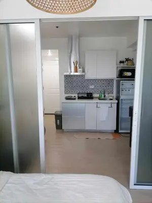 a kitchen with white cabinets and a stove top oven at Luxury 1Bedroom Condo Unit Near Manila Airport - Azure Resort Residences in Manila