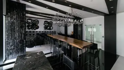 a kitchen with a bar with black and white walls at Luxury 1Bedroom Condo Unit Near Manila Airport - Azure Resort Residences in Manila