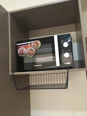 a microwave on a shelf in a cabinet at Studio in the Metro I Near MRT I WiFi in Manila