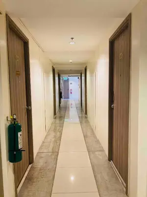 a long hallway with two doors and a long hallwayngth at Studio in the Metro I Near MRT I WiFi in Manila
