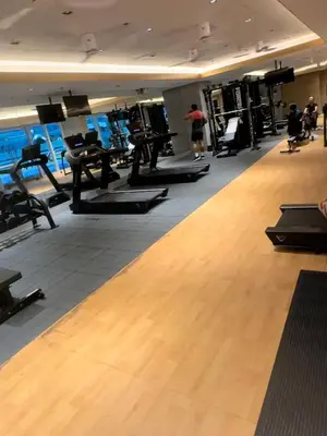 a gym with a bunch of treadmills and machines at Cozy 1 BR in EDSA Mandaluyong in Manila