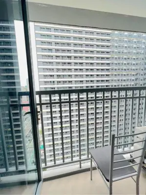 a view of a large building from a balcony at Cozy 1 BR in EDSA Mandaluyong in Manila