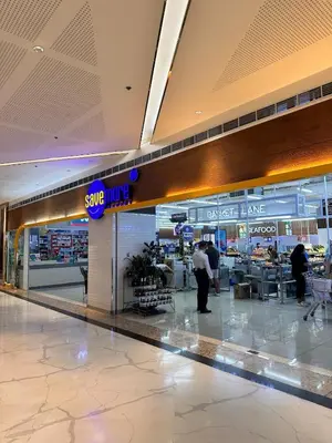 a baggage claim area in an airport with people walking around at Cozy 1 BR in EDSA Mandaluyong in Manila