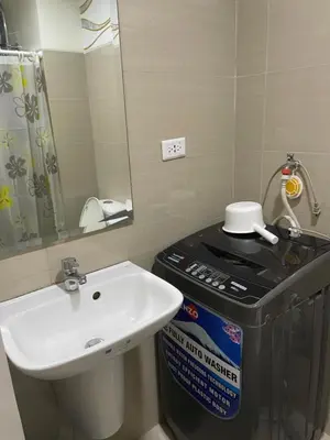 a bathroom with a sink and a mirror at shore residences 1 -City Spark staycation in Manila