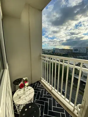 a balcony with a table and chairs and a window at shore residences 1 -City Spark staycation in Manila