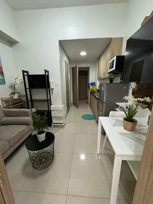 a living room with a couch and a kitchen at Shore 2 Residences Tower 1 in Manila