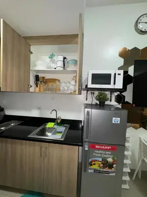 a small kitchen with a refrigerator and a sink at Shore 2 Residences Tower 1 in Manila