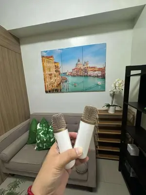 a person holding a wii remote in a living room at Shore 2 Residences Tower 1 in Manila