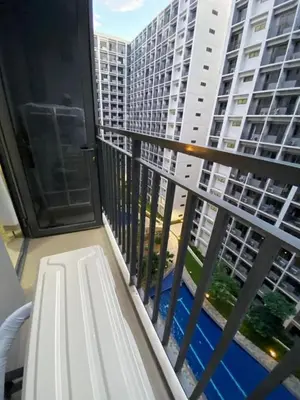 a balcony with a view of a large building at Staycation bliss! Shore 2 B1! in Manila