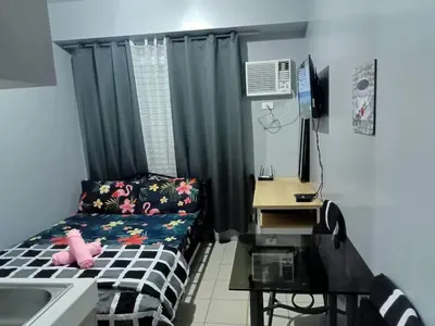 a small room with a bed and a sink at Berto's Staycation Long Term and Short Term in Manila