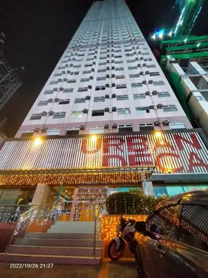 a tall building with a motorcycle parked in front of it at Berto's Staycation Long Term and Short Term in Manila