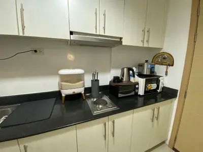 a kitchen with a counter top with a coffee maker at Sea Crib in Manila
