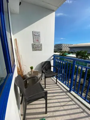 a balcony with two chairs and a table at Sea Crib in Manila