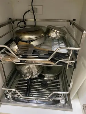 a shelf in a kitchen with some pans and utensils at Sea Crib in Manila