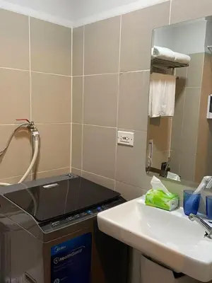 a bathroom with a sink and a mirror at FX Condotel 3322 in Manila