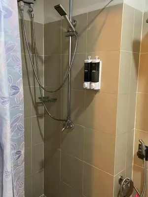 a shower in a bathroom with a glass door at FX Condotel 3322 in Manila