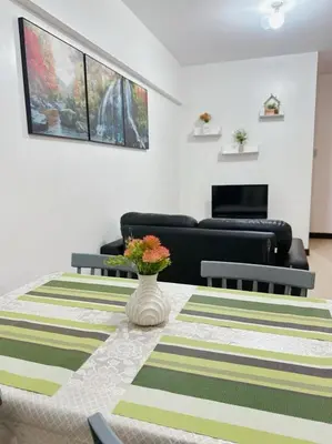 a living room with a couch and a table at Alea Residence 21 in Manila