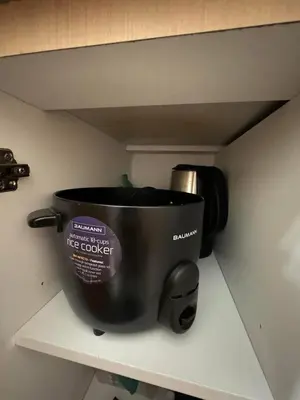 a coffee pot sitting on a shelf in a kitchen at Staycation at Field Residences Near Airport in Manila