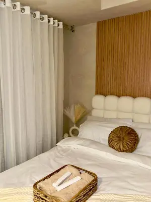 a bedroom with a bed with a tray on it at 2BR - Azure Staycation Parañaque in Manila