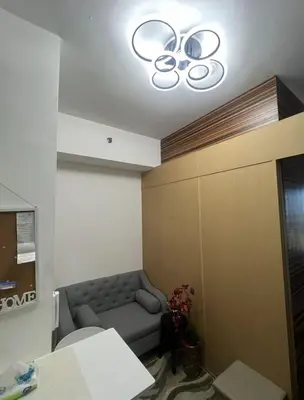 a waiting room with a couch and a light at Luxury for Less next to BGC and Makati CBD in Manila