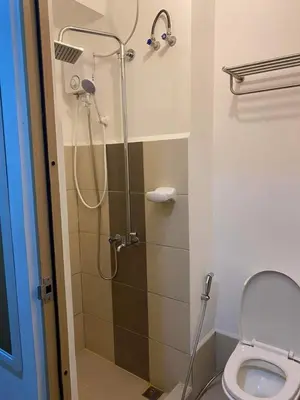 a bathroom with a shower and a toilet at Luxury for Less next to BGC and Makati CBD in Manila