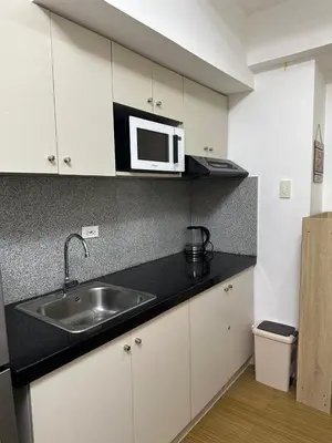 a kitchen with a sink and a microwave at Luxury for Less next to BGC and Makati CBD in Manila