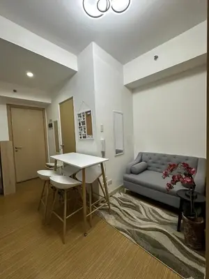 a living room with a table and a couch at Luxury for Less next to BGC and Makati CBD in Manila