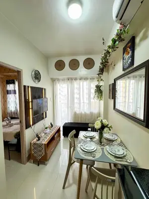 a living room with a table and a couch at 2BR Condo Staycation NearAirport in Manila