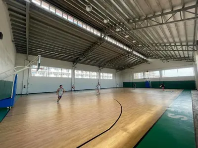 a group of people playing a game of bowling in a gym at 2BR Condo Staycation NearAirport in Manila