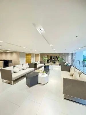 a large living room with couches and tables at 2BR Condo Staycation NearAirport in Manila
