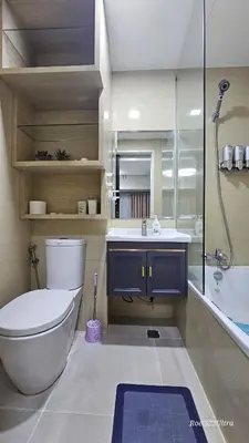 a bathroom with a toilet and a sink and a shower at Your HOME away from home in Manila