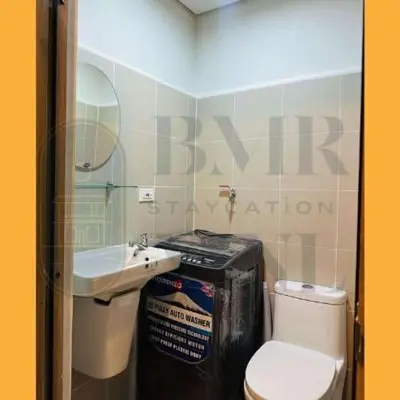 a small bathroom with a toilet and a sink at Staycation BMR Mnl at Coast Residences in Manila