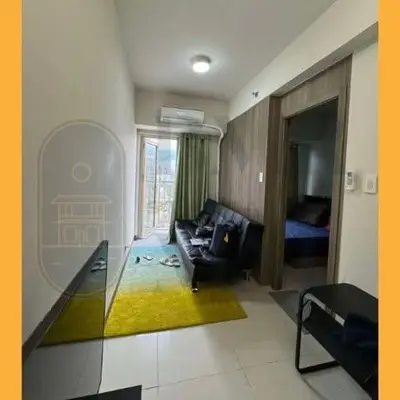 a living room with a couch and a bed at Staycation BMR Mnl at Coast Residences in Manila