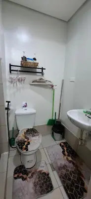 a bathroom with a toilet and a sink at Charles Haven's Crib - Spring Residences in Manila